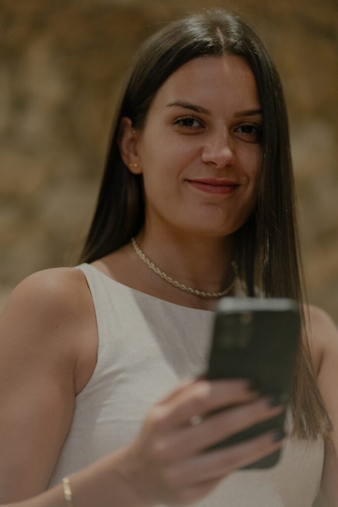A woman holding a cell phone in her hands